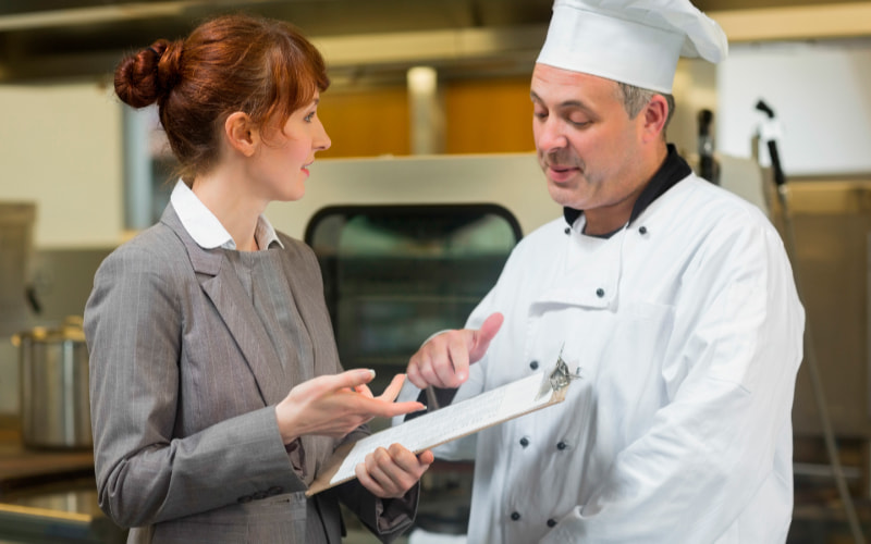 Woman and chef discussing business