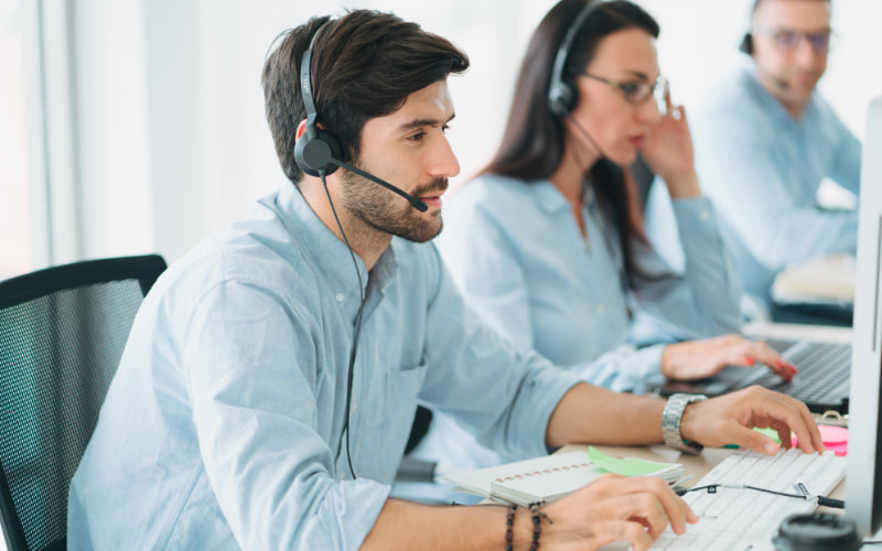 Office workers speaking on phones